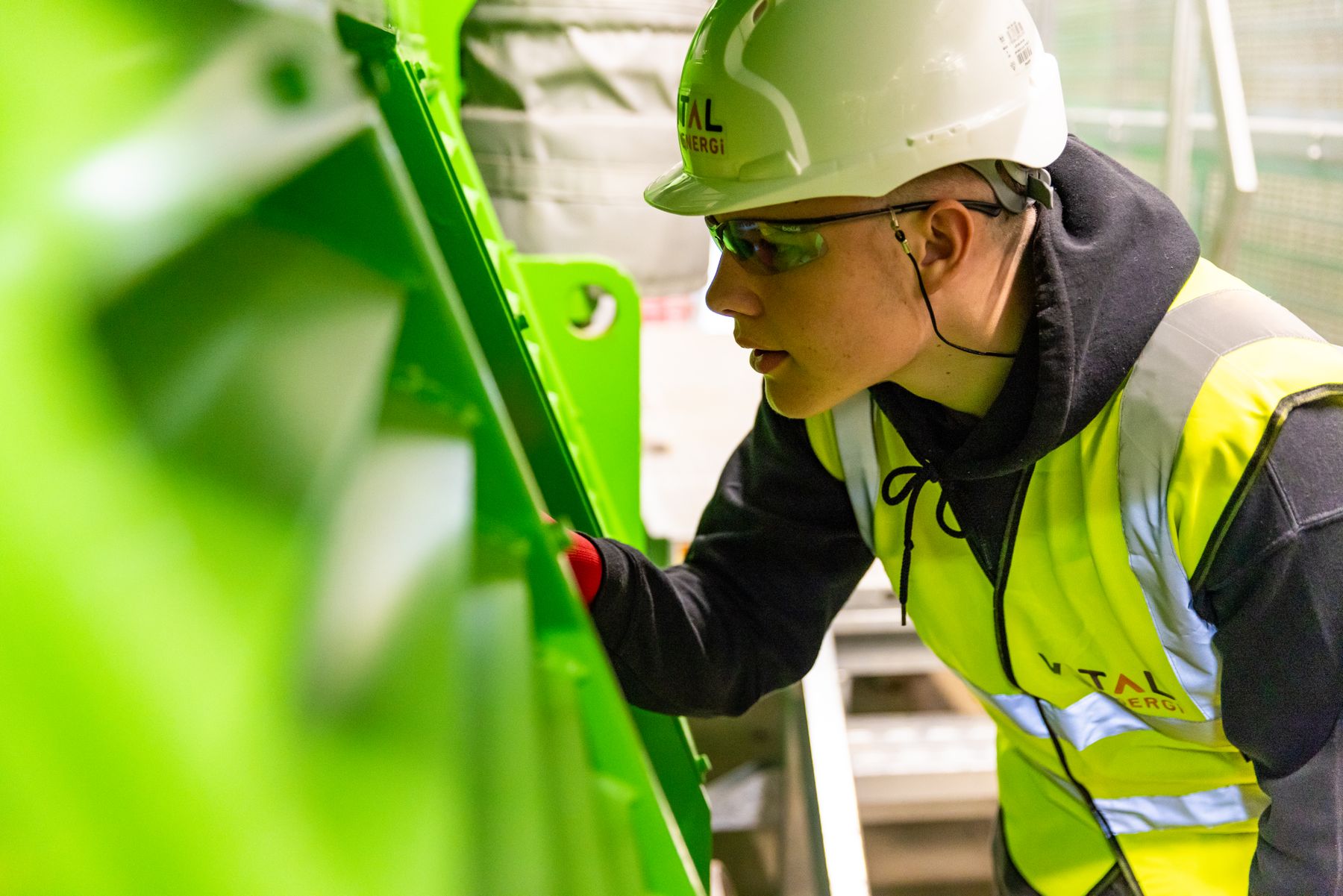 Factory technician inspecting industrial equipment