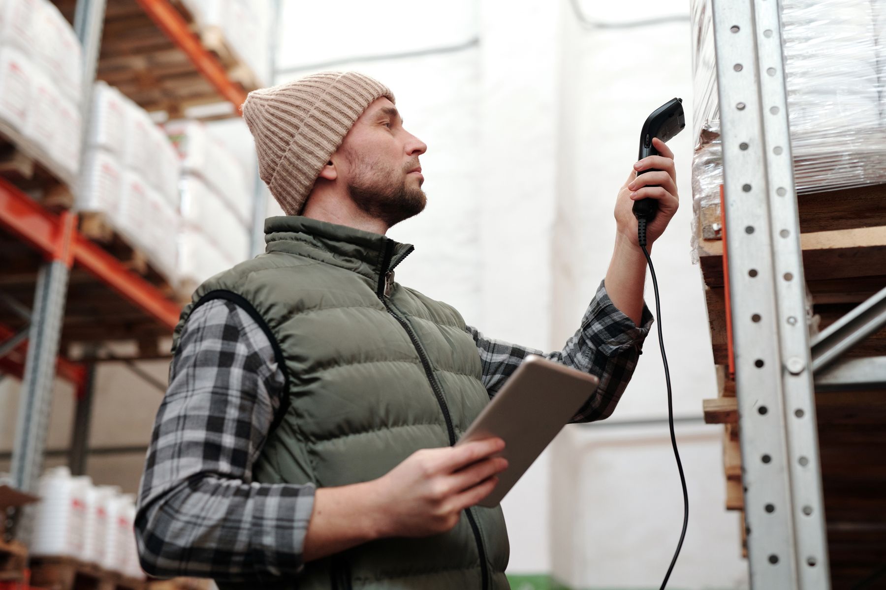 Warehouse worker scanning inventory with a handheld reader